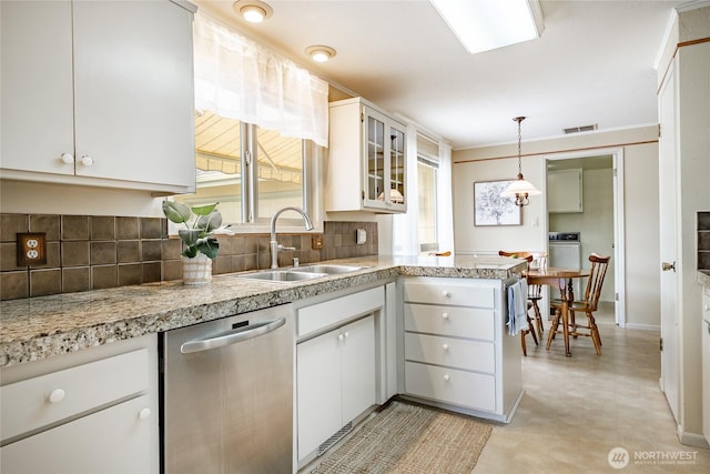 1021 Garden Dr, Lynden, WA 98264 - kitchen with dishwasher, decorative backsplash, light countertops, and white cabinetry