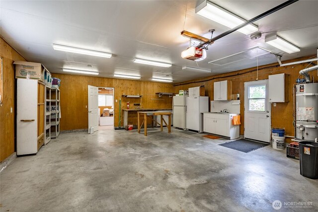 1021 Garden Dr, Lynden, WA 98264 - garage featuring a garage door opener, freestanding refrigerator, secured water heater, a workshop area, and wood walls