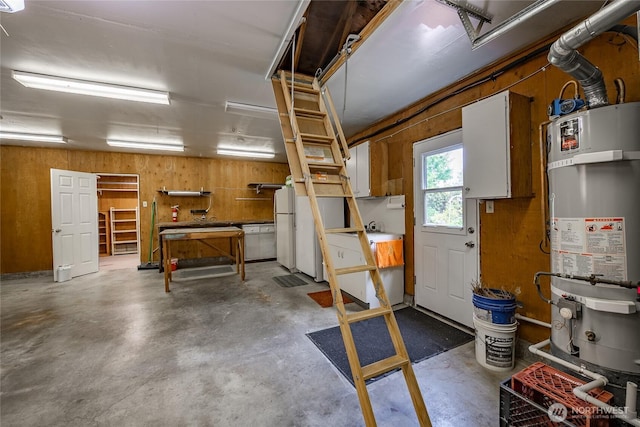 1021 Garden Dr, Lynden, WA 98264 - garage featuring strapped water heater, freestanding refrigerator, and wood walls