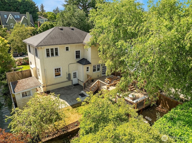 2318 33rd Ave S, Seattle, WA 98144 - rear view of house with a shingled roof, a deck, a patio, and view of wooded area