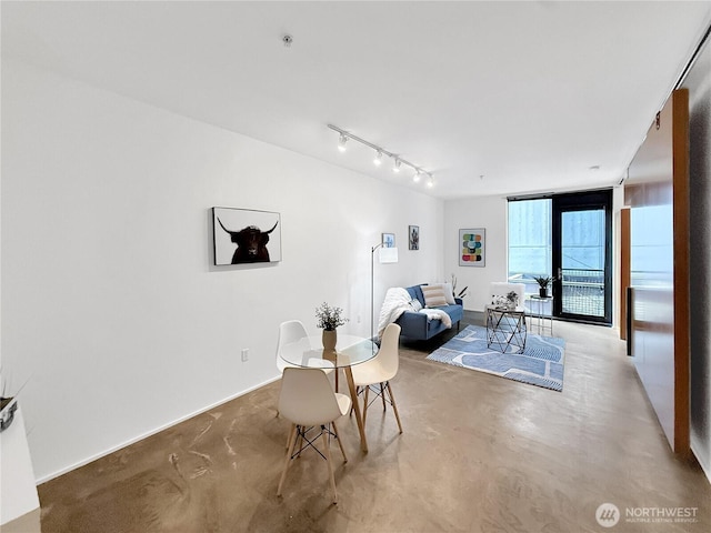 1111 E Pike St Unit 205, Seattle, WA 98122 - dining area with finished concrete flooring and rail lighting