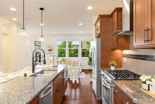 1087 10th Ave NE, Issaquah, WA 98029 - kitchen with wall chimney exhaust hood, stainless steel appliances, brown cabinetry, dark wood-style floors, and light stone countertops