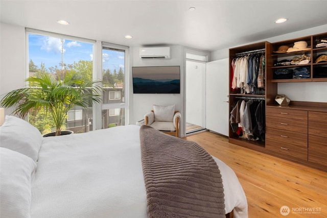 866 NE 96th St, Seattle, WA 98115 - bedroom featuring light wood-style flooring, a wall mounted AC, and recessed lighting