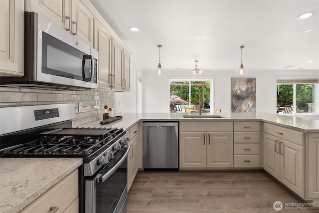 14219 284th Pl NE, Duvall, WA 98019 - kitchen with stainless steel appliances, healthy amount of natural light, recessed lighting, light wood-style floors, and backsplash