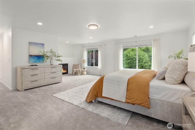 14219 284th Pl NE, Duvall, WA 98019 - bedroom with light carpet, recessed lighting, and a glass covered fireplace