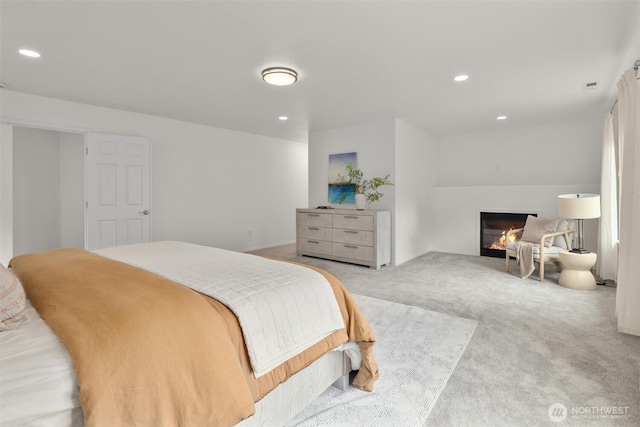 14219 284th Pl NE, Duvall, WA 98019 - bedroom featuring light colored carpet, a glass covered fireplace, and recessed lighting