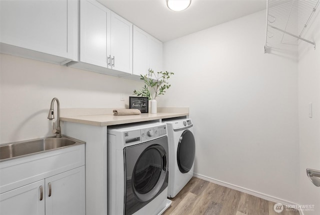 14219 284th Pl NE, Duvall, WA 98019 - laundry area with separate washer and dryer, cabinet space, and light wood-style flooring
