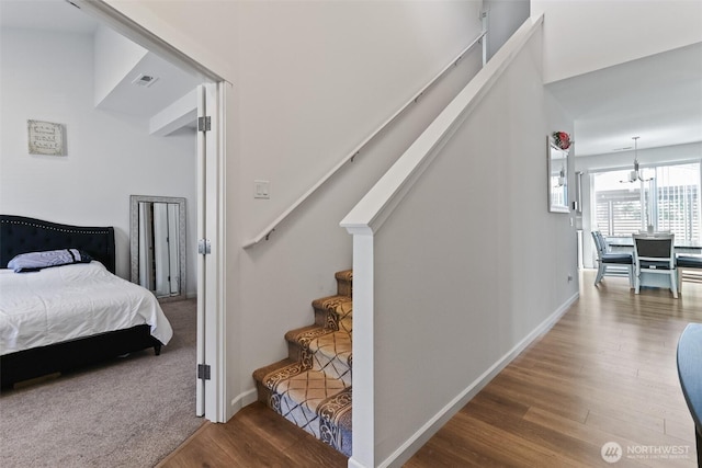202 191st Street Ct E, Spanaway, WA 98387 - stairway featuring wood finished floors and a chandelier