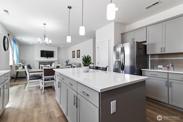 202 191st Street Ct E, Spanaway, WA 98387 - kitchen with stainless steel fridge with ice dispenser, gray cabinets, light wood-style flooring, and light countertops