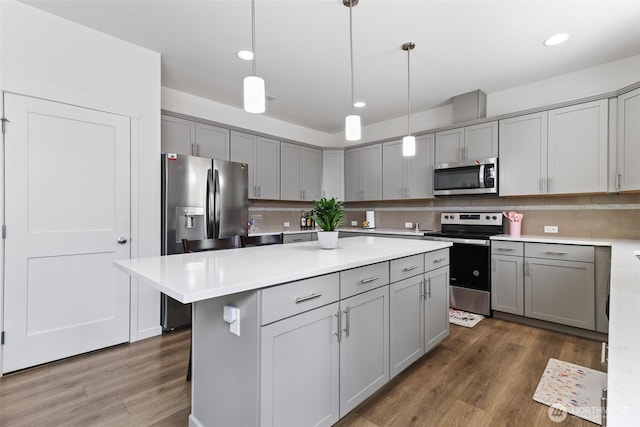 202 191st Street Ct E, Spanaway, WA 98387 - kitchen featuring appliances with stainless steel finishes, gray cabinets, dark wood-type flooring, a center island, and recessed lighting