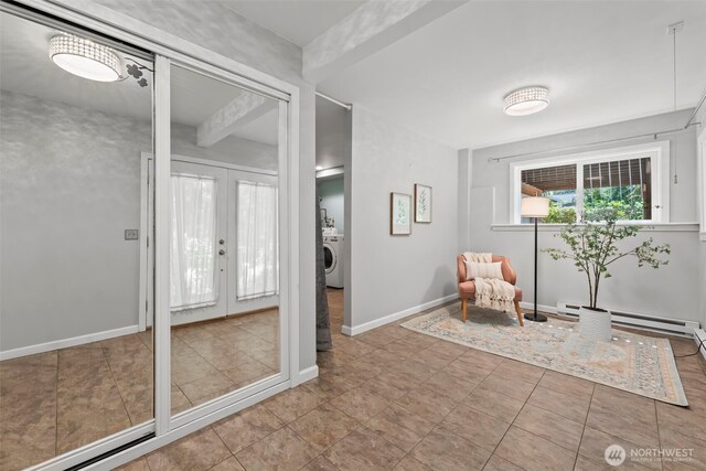 12170 Viewcrest Pl NE, Bainbridge Island, WA 98110 - sitting room featuring washer / dryer, a baseboard radiator, and french doors