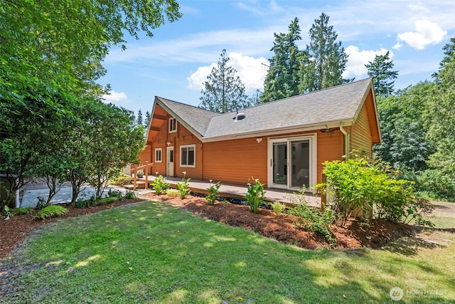 12170 Viewcrest Pl NE, Bainbridge Island, WA 98110 - rear view of house featuring a wooden deck, a lawn, and roof with shingles