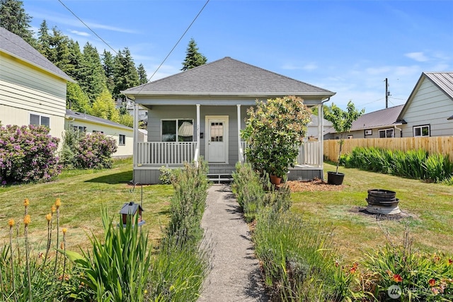 1211 Larch St, Raymond, WA 98577 - view of front of house featuring covered porch, a fire pit, and a shingled roof