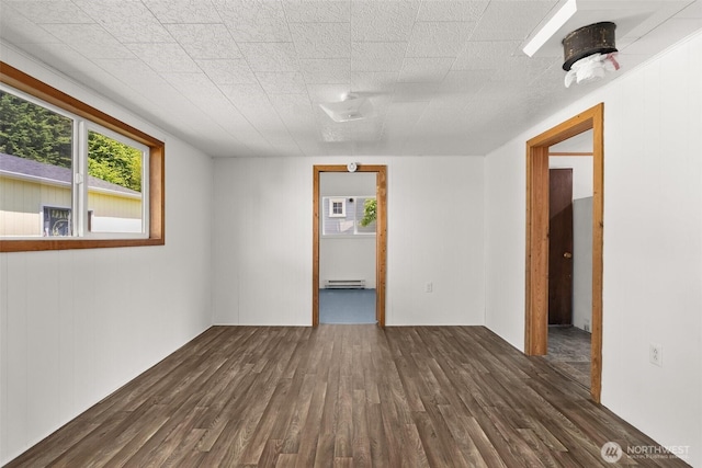 1211 Larch St, Raymond, WA 98577 - spare room featuring dark wood-type flooring and baseboard heating