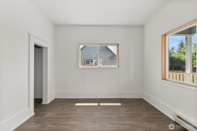 1211 Larch St, Raymond, WA 98577 - unfurnished room with baseboard heating and dark wood-style floors