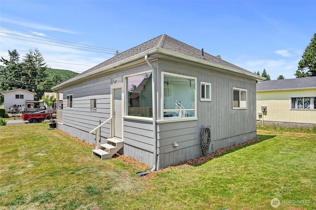 1211 Larch St, Raymond, WA 98577 - view of home's exterior featuring entry steps, a yard, and a shingled roof