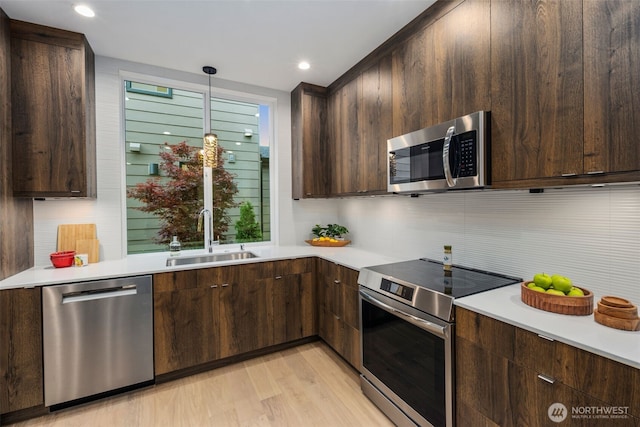 2665 51st Ave SW, Seattle, WA 98116 - kitchen featuring stainless steel appliances, light countertops, backsplash, and recessed lighting