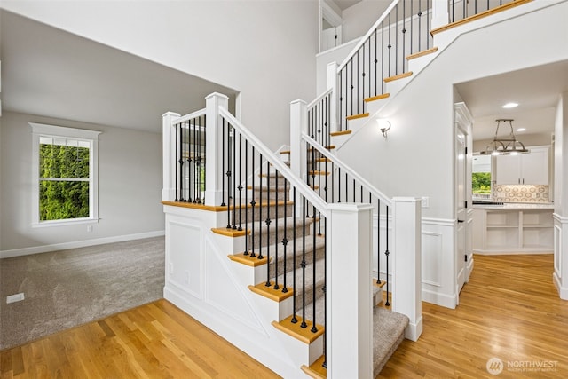 14808 172nd St E, Orting, WA 98360 - staircase featuring wood finished floors and a towering ceiling