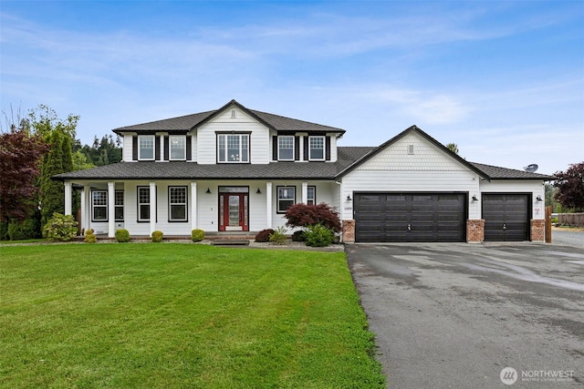 14808 172nd St E, Orting, WA 98360 - view of front of house featuring an attached garage, asphalt driveway, a porch, and a front yard