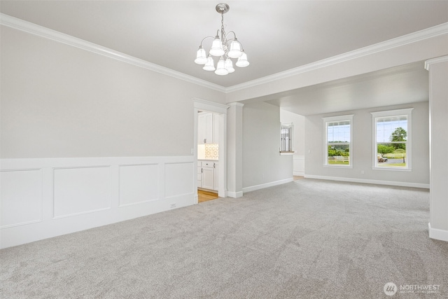 14808 172nd St E, Orting, WA 98360 - unfurnished room with light colored carpet, a chandelier, crown molding, wainscoting, and a decorative wall