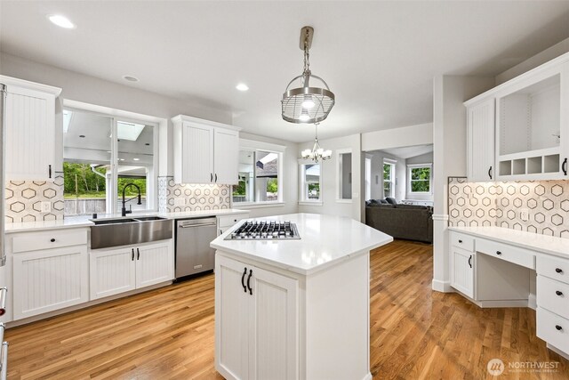 14808 172nd St E, Orting, WA 98360 - kitchen with appliances with stainless steel finishes, backsplash, light countertops, a center island, and recessed lighting