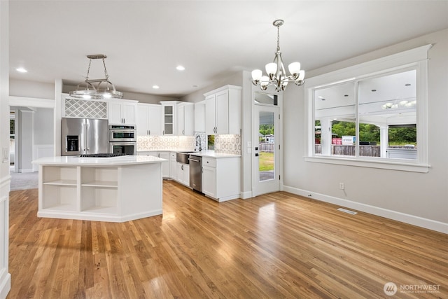14808 172nd St E, Orting, WA 98360 - kitchen featuring stainless steel appliances, a chandelier, light countertops, plenty of natural light, and recessed lighting
