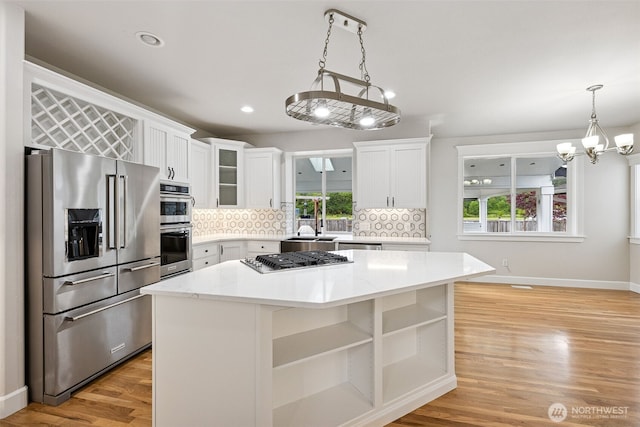 14808 172nd St E, Orting, WA 98360 - kitchen with stainless steel appliances, plenty of natural light, tasteful backsplash, and recessed lighting