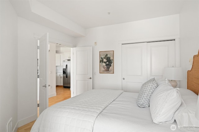 1015 Railroad Ave Unit 518, Bellingham, WA 98225 - bedroom with stainless steel fridge, light wood finished floors, and a closet