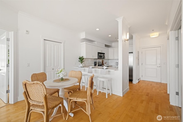 1015 Railroad Ave Unit 518, Bellingham, WA 98225 - dining area featuring ornamental molding, light wood finished floors, and recessed lighting