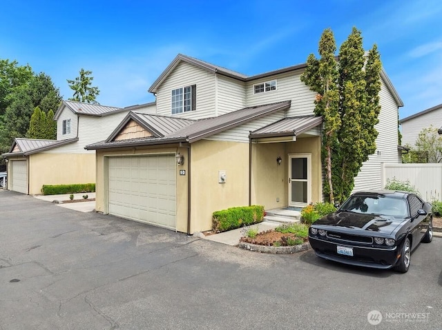 418 17th St SE Unit 9D, Auburn, WA 98002 - view of front facade with a standing seam roof, a metal roof, and stucco siding