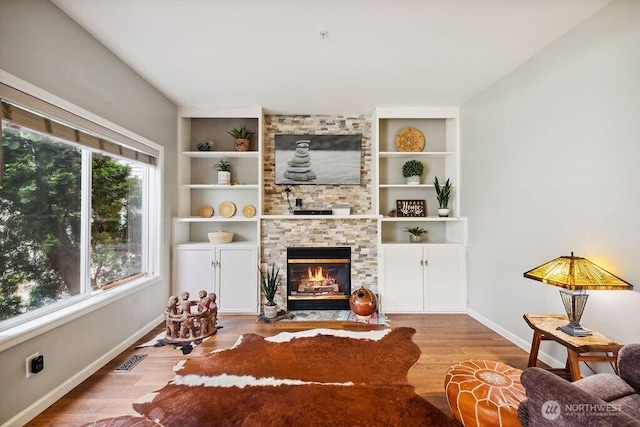 418 17th St SE Unit 9D, Auburn, WA 98002 - living room with a fireplace, wood finished floors, and built in shelves