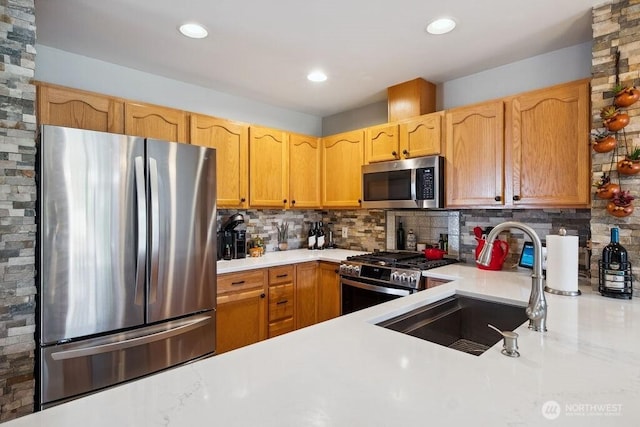418 17th St SE Unit 9D, Auburn, WA 98002 - kitchen featuring appliances with stainless steel finishes, light countertops, backsplash, and recessed lighting