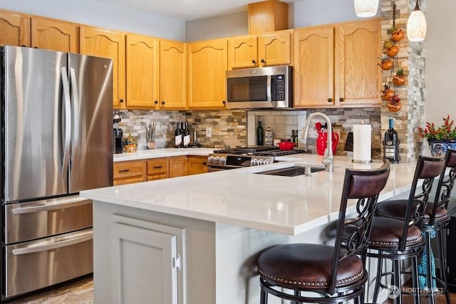 418 17th St SE Unit 9D, Auburn, WA 98002 - kitchen with appliances with stainless steel finishes, a peninsula, backsplash, and a breakfast bar area
