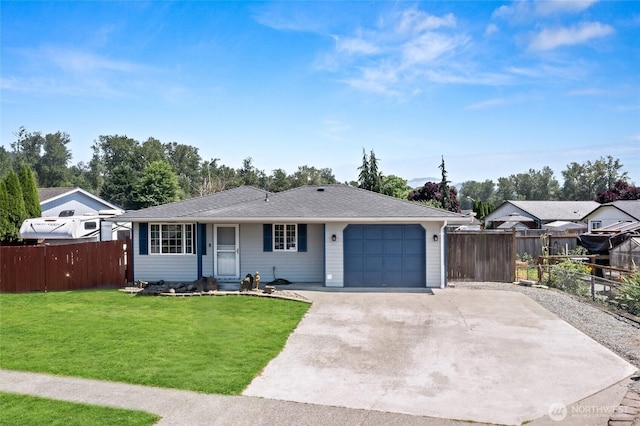 307 Brown St SE, Orting, WA 98360 - ranch-style home with a garage, a shingled roof, and driveway