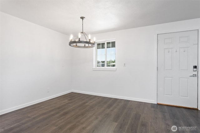 307 Brown St SE, Orting, WA 98360 - unfurnished dining area with a chandelier and dark wood finished floors