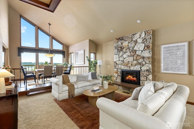 10300 64th Pl W, Mukilteo, WA 98275 - carpeted living room with high vaulted ceiling, a water view, and a fireplace