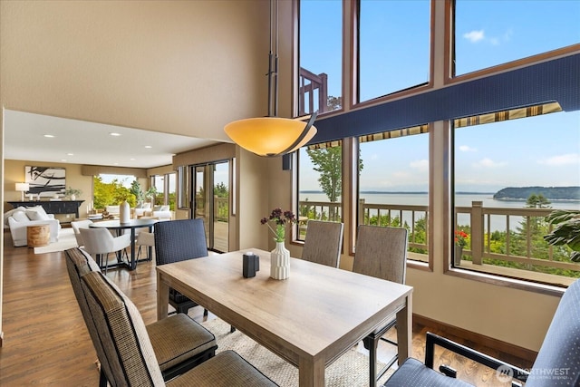 10300 64th Pl W, Mukilteo, WA 98275 - dining space featuring a water view, wood finished floors, a towering ceiling, and recessed lighting