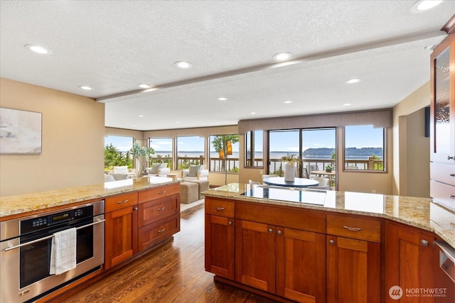 10300 64th Pl W, Mukilteo, WA 98275 - kitchen featuring black electric cooktop, oven, dark wood-style flooring, plenty of natural light, and recessed lighting