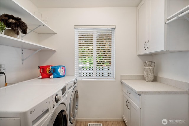 3089 W Lake Sammamish Pkwy NE, Redmond, WA 98052 - laundry room with washing machine and dryer, cabinet space, and light wood-type flooring