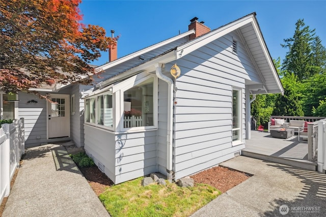3089 W Lake Sammamish Pkwy NE, Redmond, WA 98052 - view of property exterior featuring a chimney, a deck, and an outdoor hangout area