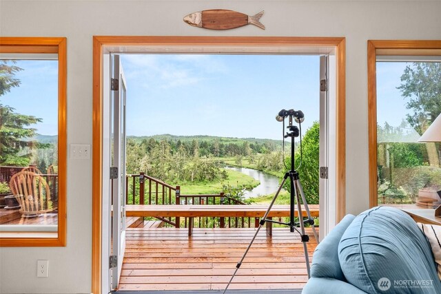 1508 Bloomhardt Rd, Raymond, WA 98577 - doorway to outside featuring a water view, plenty of natural light, and hardwood / wood-style floors