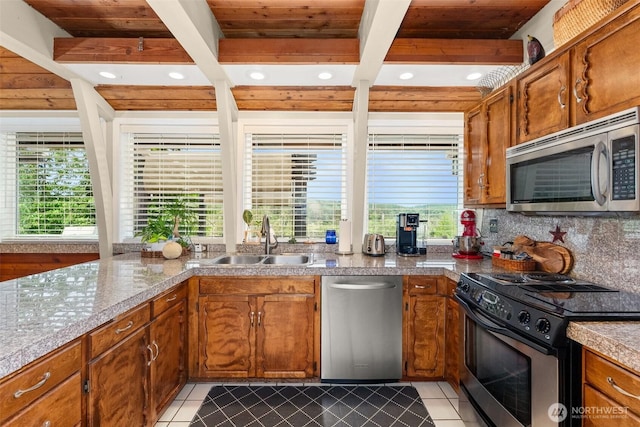 1508 Bloomhardt Rd, Raymond, WA 98577 - kitchen featuring appliances with stainless steel finishes, tile counters, light tile patterned flooring, brown cabinets, and recessed lighting