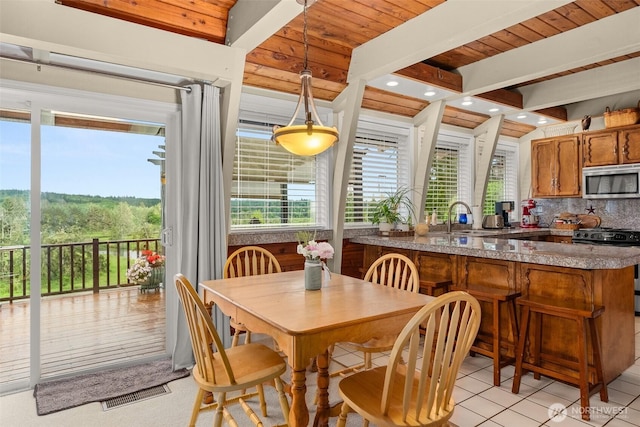 1508 Bloomhardt Rd, Raymond, WA 98577 - dining area with recessed lighting, a wood ceiling with exposed beams, and light tile patterned floors