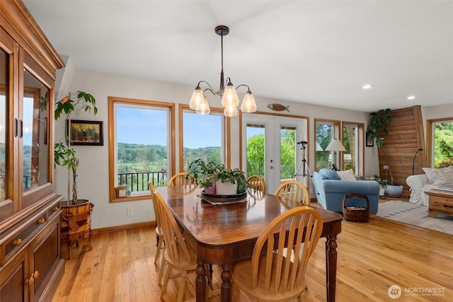 1508 Bloomhardt Rd, Raymond, WA 98577 - dining room with light wood finished floors, french doors, a chandelier, and recessed lighting