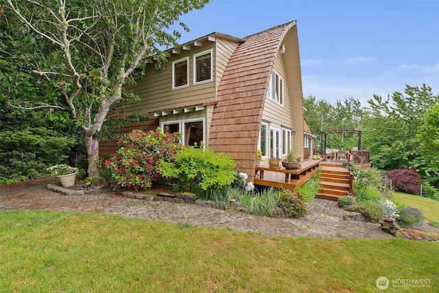 1508 Bloomhardt Rd, Raymond, WA 98577 - view of home's exterior with a deck, a lawn, and a gambrel roof