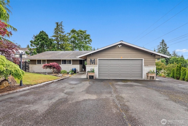 755 Elm St, Raymond, WA 98577 - ranch-style house with brick siding, asphalt driveway, a garage, and a front yard