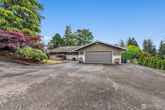 755 Elm St, Raymond, WA 98577 - view of front of home featuring an attached garage, driveway, and brick siding