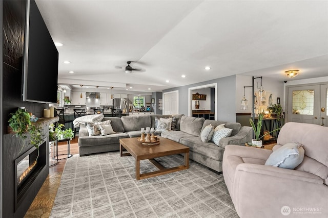 755 Elm St, Raymond, WA 98577 - living area with lofted ceiling, ceiling fan, a glass covered fireplace, and recessed lighting