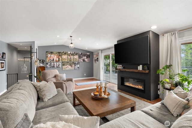 755 Elm St, Raymond, WA 98577 - living area featuring vaulted ceiling, plenty of natural light, a large fireplace, and light wood-type flooring