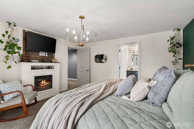 755 Elm St, Raymond, WA 98577 - bedroom with carpet floors, a chandelier, a glass covered fireplace, and ensuite bathroom